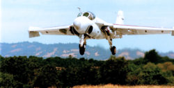 A-6E Intruder attack jet with wheels extended, about to land on an airport runway