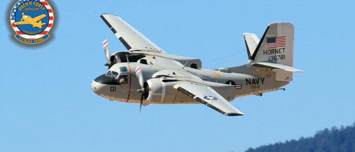 C-1A Trader aircraft in flight, viewed from the left side and slightly ahead, The plane is banking toward the camera.