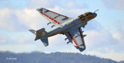 EA-6B Prowler electronic warfare jet aircraft making a steep climb and banking toward the camera, in flight.