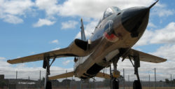 F-105F Thunderchief on the field at the Pacific Coast Air Museum. View is from ground level looking up at the right side of the nose. The open bomb bay is visible.