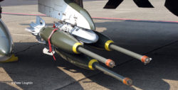 Close-up of inert 750-pound bombs with extended fuses mounted on a wing pylon of the F-4C Phantom II