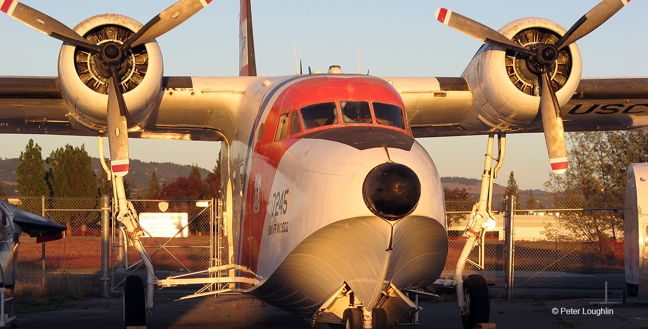 hu16e-albatross-pcam-04 HU-16E Albatross amphibian seaplane at the Pacific Coast Air Museum, viewed from the front in golden sunset light