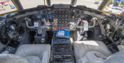 Pilot and copilot seats in the Lockheed Jetstar, shown from the rear and also showing the instrument panel, controls, and view out the windshield.