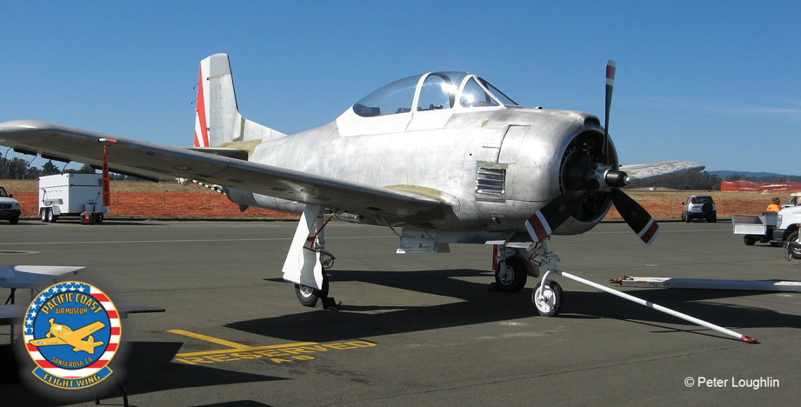 T-28 Trojan, stripped of most paint, on the ramp at the 2016 Wings Over Wine Country Air Show