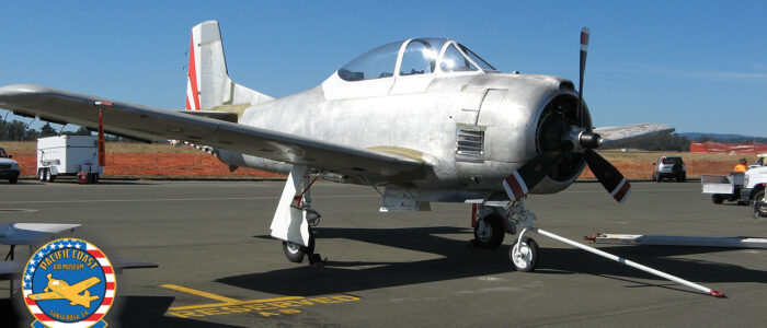 T-28 Trojan, stripped of most paint, on the ramp at the 2016 Wings Over Wine Country Air Show