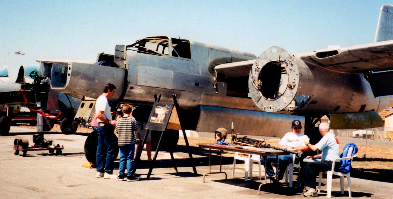 a26-invader-pcam-08 A-26 Invader on display at an air show many years ago. Shown during its restoration, it is missing its engines, plexiglass, and many other components.