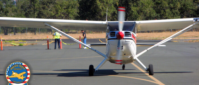 small white and red "taildragger" Stinson Voyager aircraft taxiing toward the viewer.