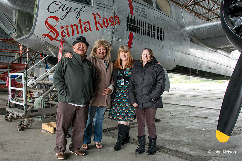 Family of Willis Tupper stands in front of PCAM A-26 Invader dubbed City of Santa Rosa