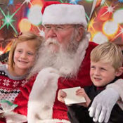 Santa Claus sitting with two young children