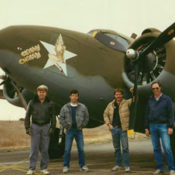 Four men standing in front of a classic WWII Lockheed bomber